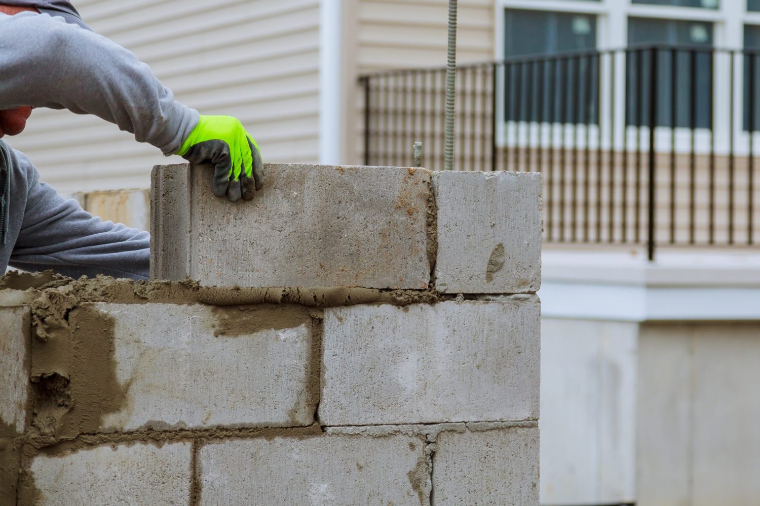 Plaster at construction masonry worker make concrete wall by cement block