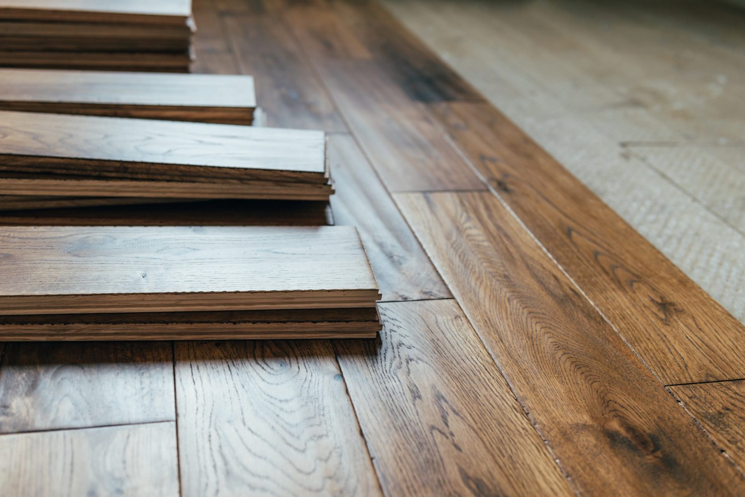 The process of house renovation with changing of the floor from carpets to solid oak wood. Beautiful golden handscraped oiled European oak brushed for added texture and fine definition of wood grain